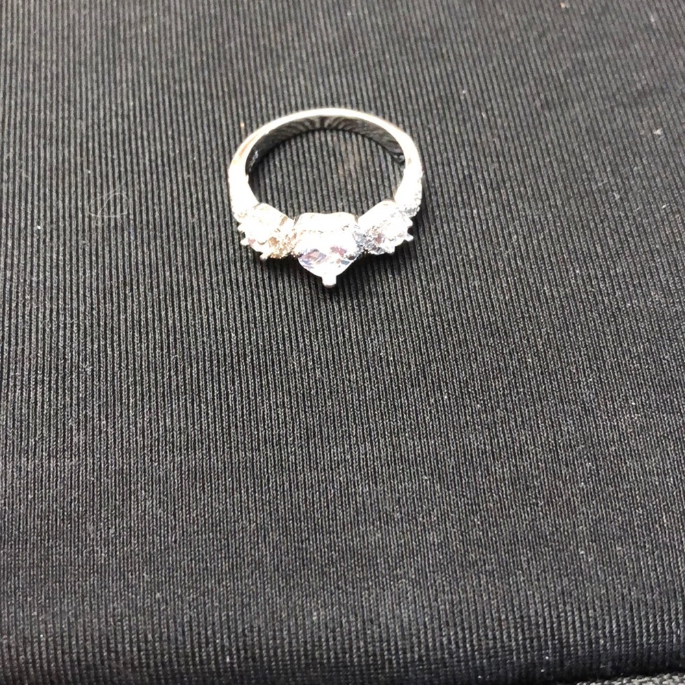 3 Stones 1 in center ❤️ shaped round on each side.